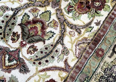Close-up of an ornate floral-patterned carpet with intricate details.