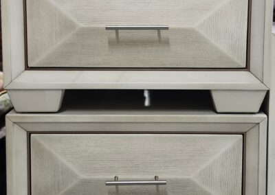Close-up of a white wooden drawer unit with two drawers.