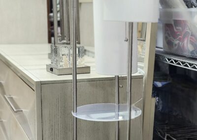 A hanging device with a white paper towel roll in a kitchen setting.