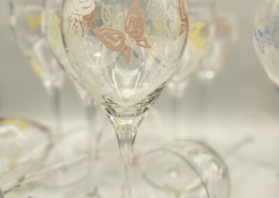 Elegant transparent wine glasses arranged softly on a light surface.