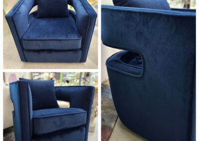 Elegant blue velvet armchair with a matching cushion, featuring a modern design.