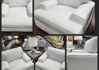 White fabric sectional sofa with cushions and ottoman in a living room.