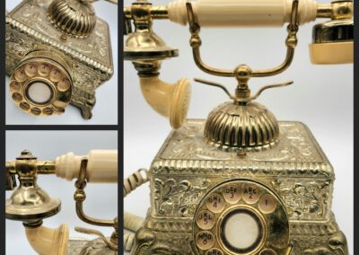 An ornate antique rotary telephone with intricate gold detailing.