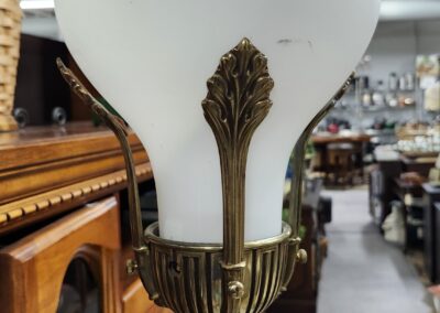 Ornate vintage lamp with frosted glass shade and intricate brass detailing.