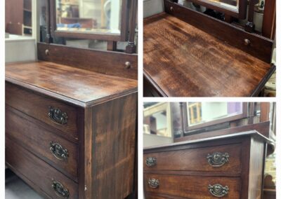 Vintage wooden dresser with mirror and brass handles.