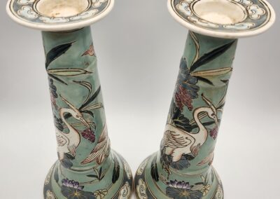 Pair of decorative ceramic vases with crane and floral motifs.