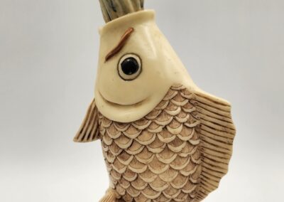 Intricately carved fish sculpture with detailed scales and expressive eye.