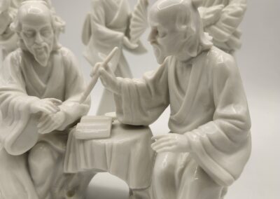 White porcelain figurines depicting a biblical scene with Jesus and disciples.