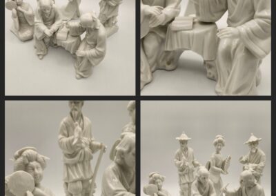 White porcelain figurines depicting elegant social scenes.