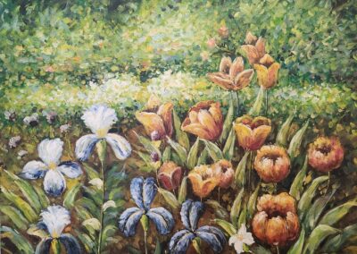 Colorful tulips and irises blooming in a lush garden.