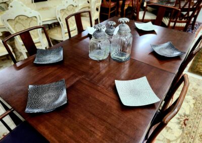 Dining table set with plates and glasses for six.