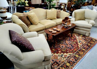 Cozy living room with beige sofas and a colorful Persian rug.