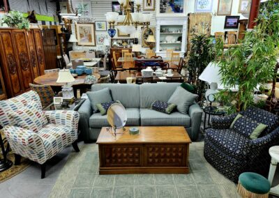 Cozy living room setup with sofas, armchairs, and wooden coffee table.
