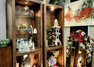 Decorative shelves with lights showcasing elegant glassware and figurines.