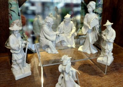 A set of chess pieces with intricate designs on a wooden surface.