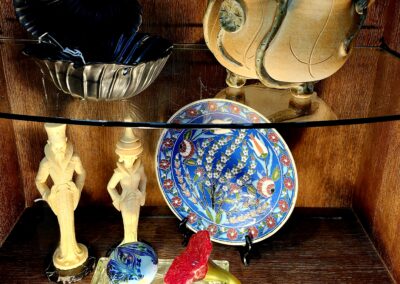 A collection of unique decorative items displayed on shelves.