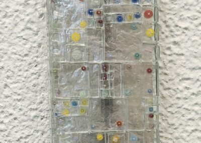 Glass mosaic artwork with colorful square patterns.