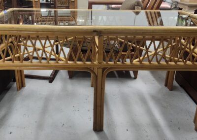 Rattan table with glass top in store.