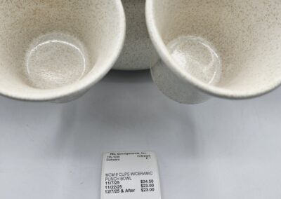 Two ceramic cups with price tag displayed.