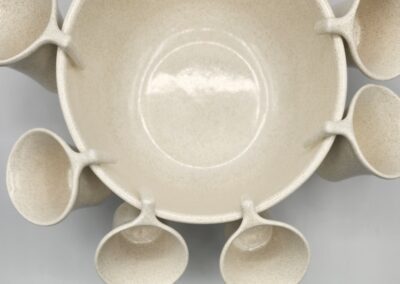 Beige ceramic bowl with attached cups.