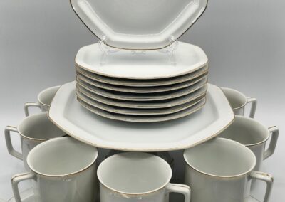 White dinnerware set with cups and plates.