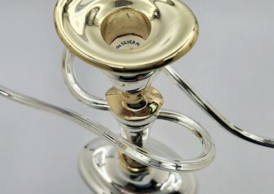 Silver and gold trumpet mouthpiece close-up.