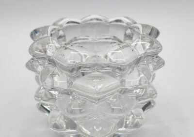 Faceted glass tealight holder on white background.