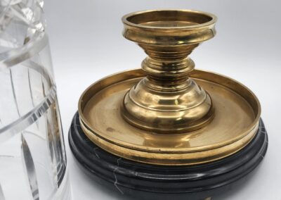 Brass candlestick with black marble base.
