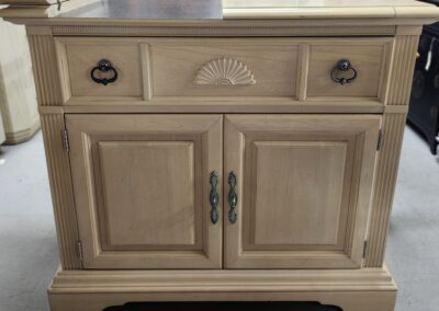 Wooden cabinet with decorative drawer handles.