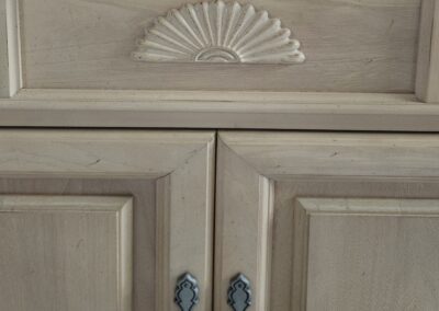 Wooden cabinet with decorative carved design.