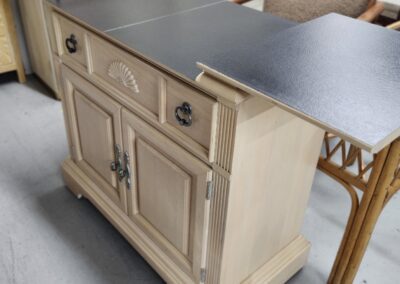 Wooden sideboard with extended black tabletop.