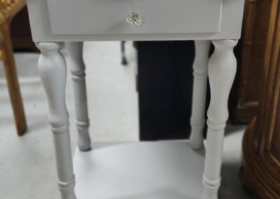 White wooden side table with drawer.