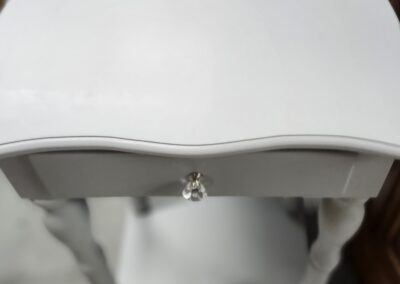 White wooden side table with drawer.