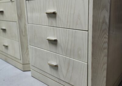 Wooden three-drawer cabinet with metal handles.