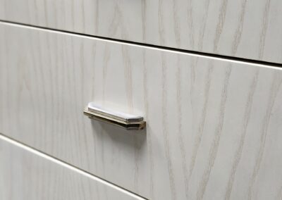 White wooden drawers with silver handles.