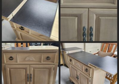 Wooden cabinet with black top, decorative details.