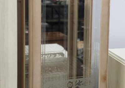 Tall wooden glass display cabinet with mirror.