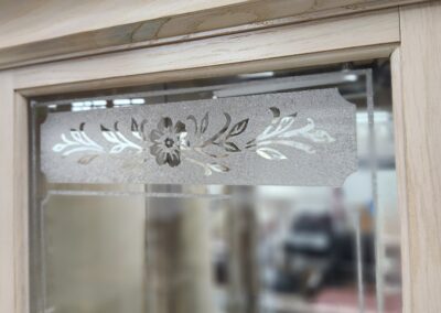 Wooden cabinet with decorative floral glass panel.