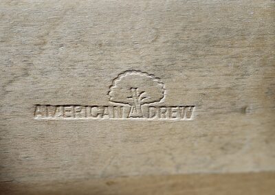 Wood engraving with "American Drew" logo.