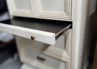 White cabinet with open drawer.
