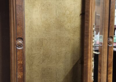 Empty wooden cabinet with open glass door.
