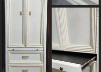 White cabinet with drawers and gold handles.
