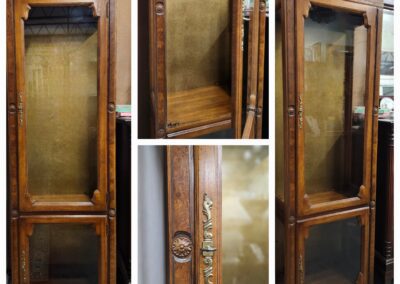 Antique wooden display cabinet with glass doors.