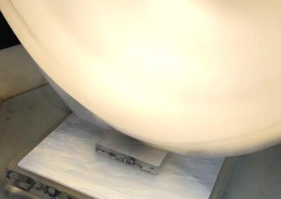 White urinal in a public restroom.