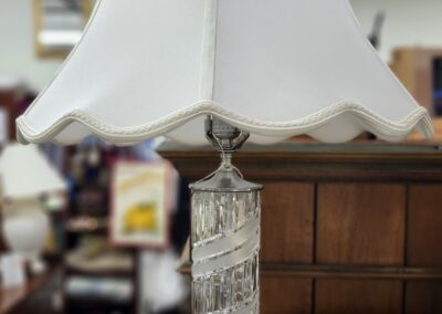 Glass table lamp with white fabric shade.