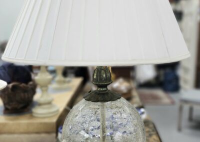 Elegant lamp with white shade on table.