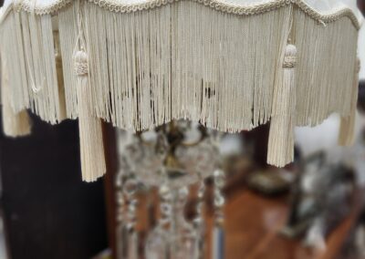 Vintage lamp with ornate fringe shade.