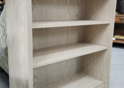 Wooden bookshelf with three empty shelves.