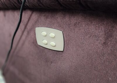 Brown fabric sofa with control buttons.