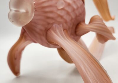 Pink glass sea creature sculpture on display.